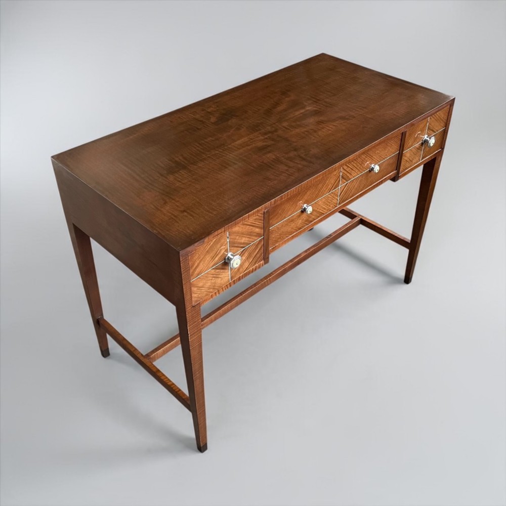 An Art Deco writing desk with geometric chevron parquetry drawer fronts, fine line inlay, and octagonal pulls on slender tapered legs. View XIII