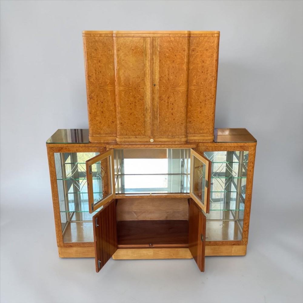 An Art Deco burr walnut cocktail cabinet with open upper doors revealing a mirrored interior, flanked by lower etched glass display sections. View IV