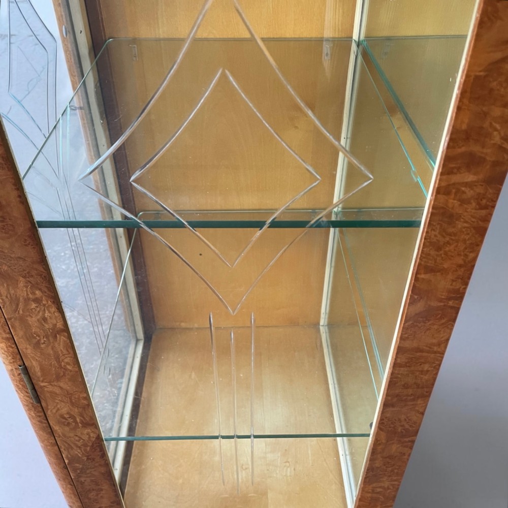 An Art Deco burr walnut cocktail cabinet with open upper doors revealing a mirrored interior, flanked by lower etched glass display sections. View VII
