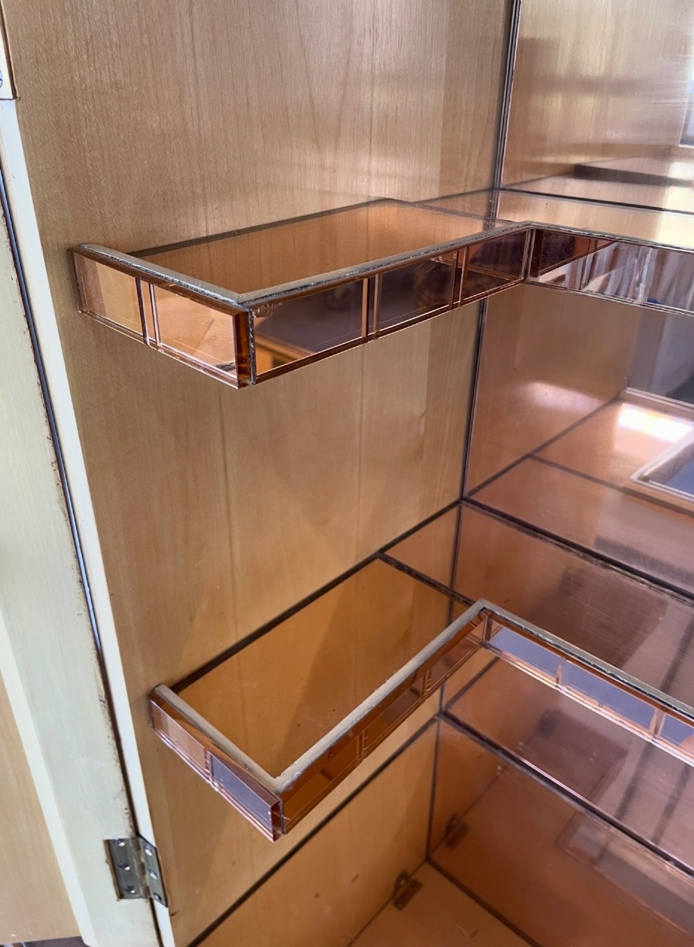 An Art Deco burr walnut cocktail cabinet with open upper doors revealing a mirrored interior, flanked by lower etched glass display sections. View IX
