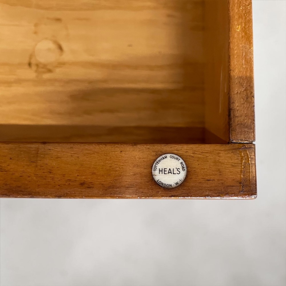 An Art Deco golden oak cabinet on stand featuring book-matched chevron wood veneers, two lower drawers, twin cupboard doors, and metal handles. View VIII