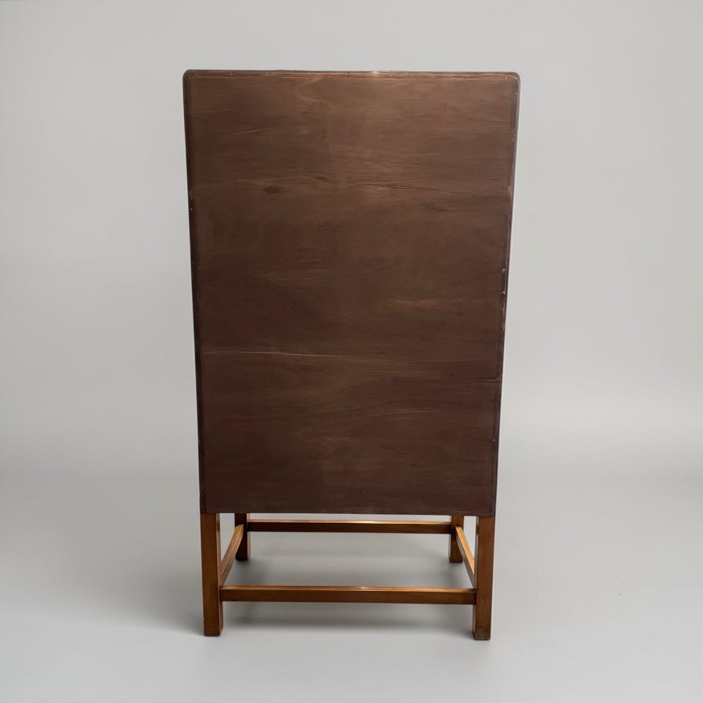 An Art Deco golden oak cabinet on stand featuring book-matched chevron wood veneers, two lower drawers, twin cupboard doors, and metal handles. View XI