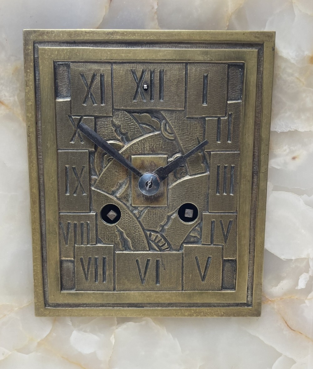 An Art Deco stepped mantel clock crafted from cream onyx and red marble with relief bronze panels depicting gazelles and a panther. View IV