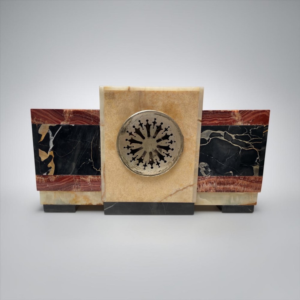 An Art Deco stepped mantel clock crafted from cream onyx and red marble with relief bronze panels depicting gazelles and a panther. View VIII