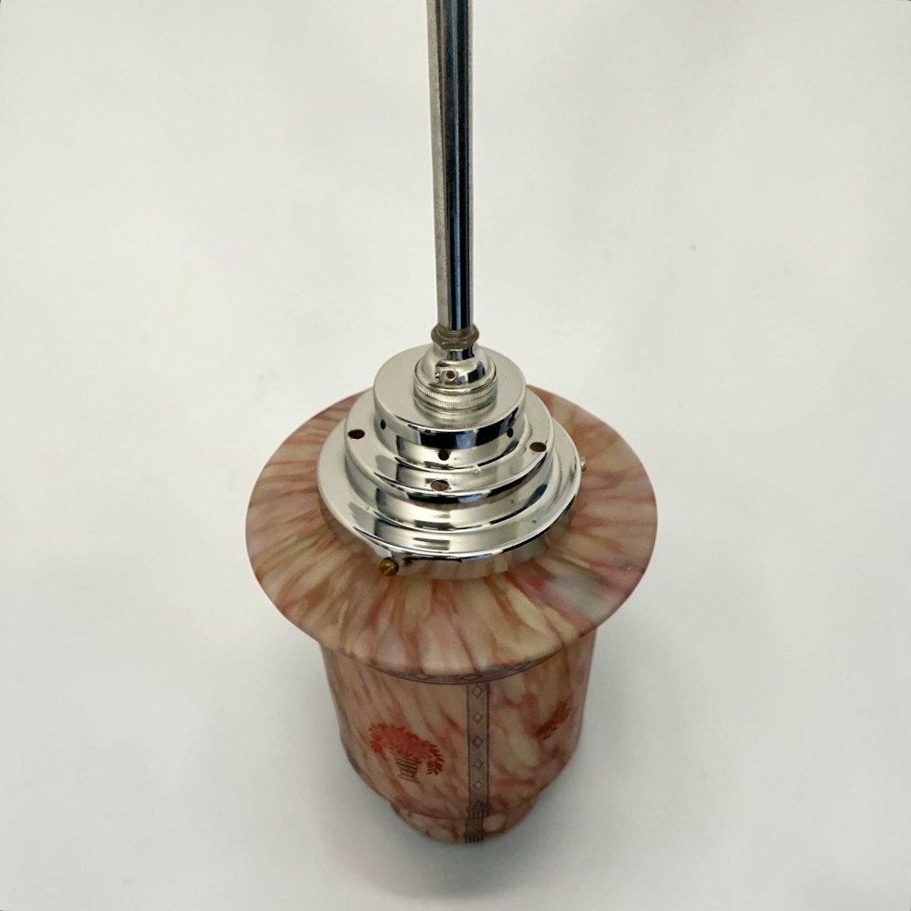 An Art Deco pendant light featuring a mottled pink glass shade with a stepped chrome gallery suspended from a central metal stem. View III