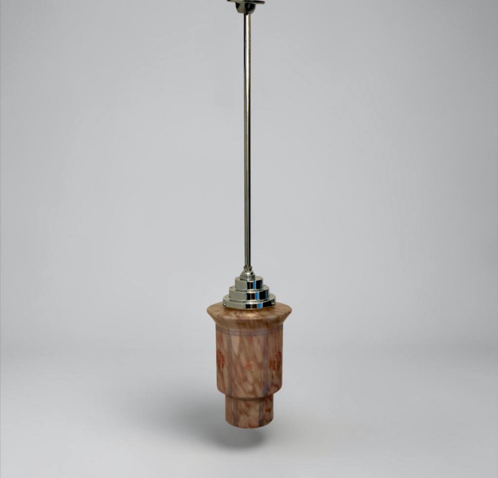 An Art Deco pendant light featuring a mottled pink glass shade with a stepped chrome gallery suspended from a central metal stem. View IV