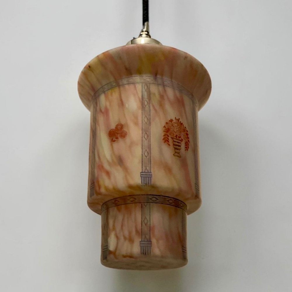 An Art Deco pendant light featuring a mottled pink glass shade with a stepped chrome gallery suspended from a central metal stem. View VI
