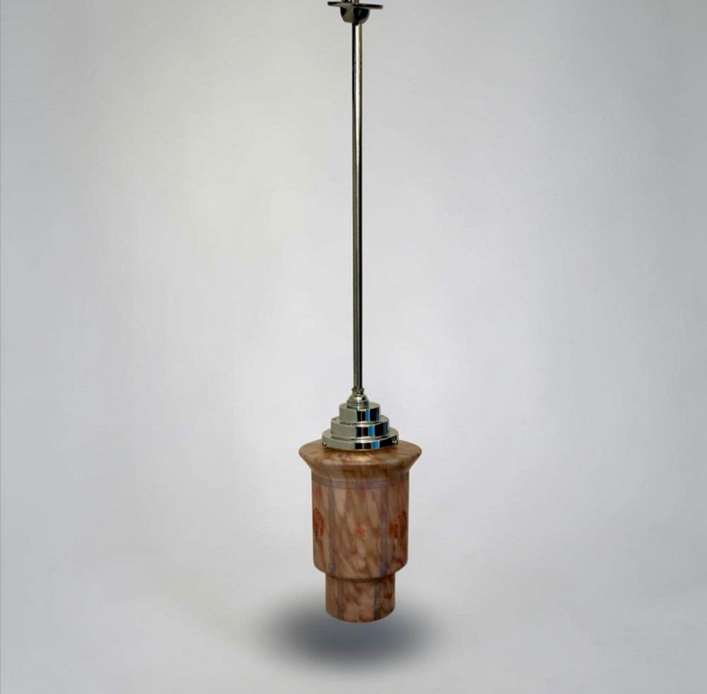 An Art Deco pendant light featuring a mottled pink glass shade with a stepped chrome gallery suspended from a central metal stem. View VII