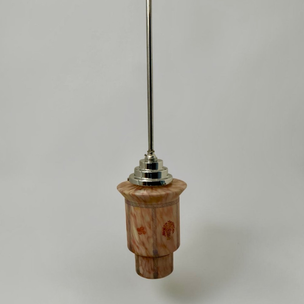 An Art Deco pendant light featuring a mottled pink glass shade with a stepped chrome gallery suspended from a central metal stem. View VIII