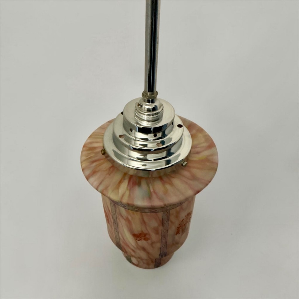 An Art Deco pendant light featuring a mottled pink glass shade with a stepped chrome gallery suspended from a central metal stem. View IX