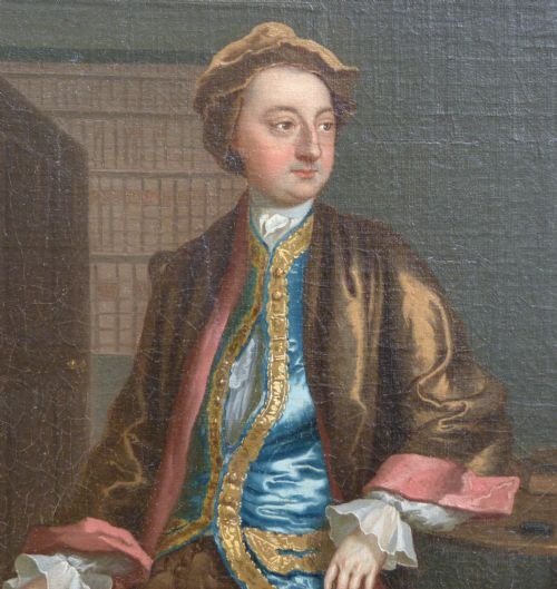 fig 1. An 18th-century oil painting depicting a seated gentleman in a blue embroidered waistcoat alongside a lady in a silver satin dress, set within an ornate carved giltwood frame.