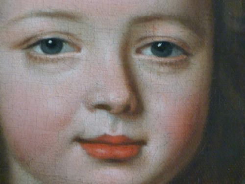 fig 3. An 18th-century oil portrait depicting a young boy in a red tunic and blue trimmed jacket, housed in an ornate carved gilded frame.