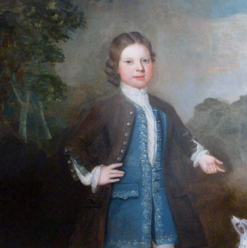 fig 1. An early 18th-century oil painting depicting a standing boy in a brown coat and blue waistcoat alongside a small dog, presented in a beaded giltwood frame.