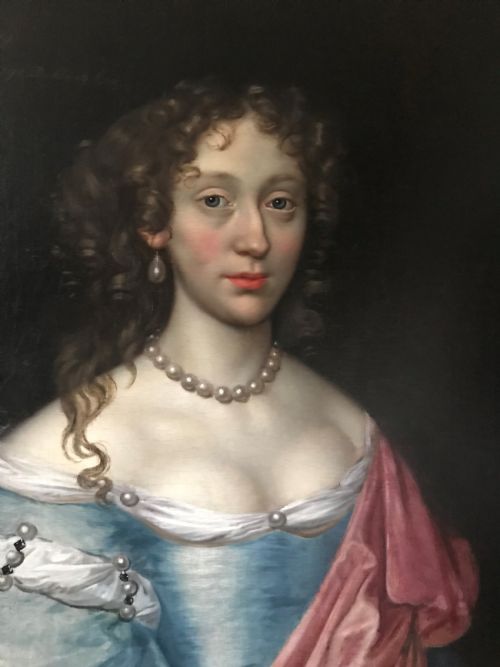 fig 1. An antique seventeenth-century oil portrait of a noblewoman in a blue dress and pearl jewellery set within an ornate carved giltwood frame.