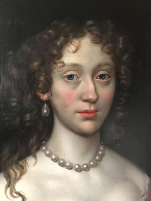 fig 2. An antique seventeenth-century oil portrait of a noblewoman in a blue dress and pearl jewellery set within an ornate carved giltwood frame.