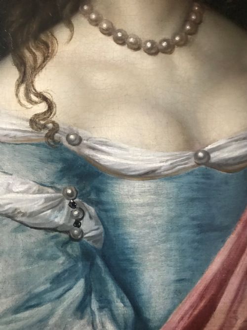 fig 3. An antique seventeenth-century oil portrait of a noblewoman in a blue dress and pearl jewellery set within an ornate carved giltwood frame.