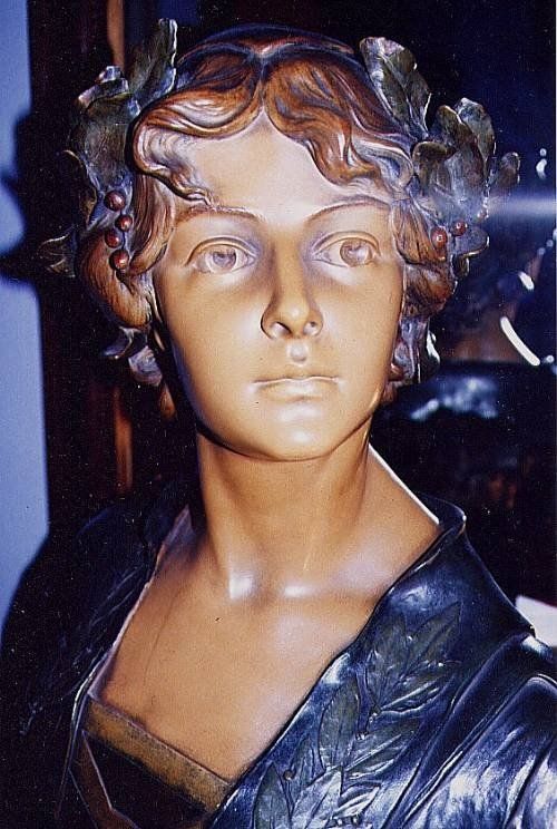 fig 3. An Art Nouveau sculpted portrait bust of the poet Sappho featuring dark bronzed drapery, warm ochre skin tones, and the inscription SAPPHO across the plinth.