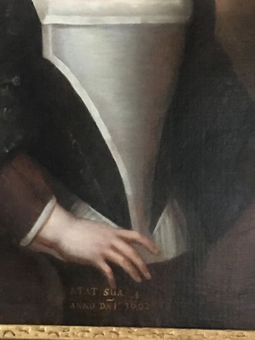fig 2. An antique seventeenth-century oil portrait of a young boy with light brown hair in period dress, set in a carved gilt frame.