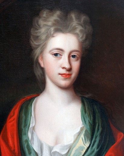fig 1. An oil portrait painting depicting a lady in green drapery and a red shawl set within an oval spandrel and a carved giltwood frame.