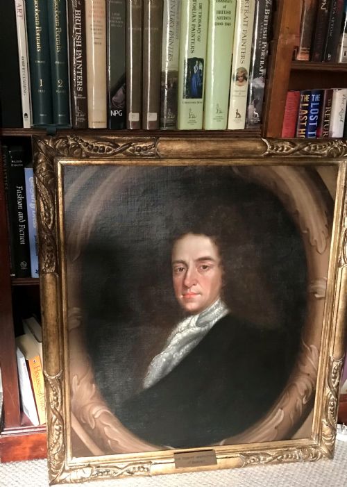 fig 3. A late 17th-century Scottish oil portrait depicting a gentleman with a dark full-bottomed wig and lace cravat set within a painted feigned oval and carved gilded wooden frame.