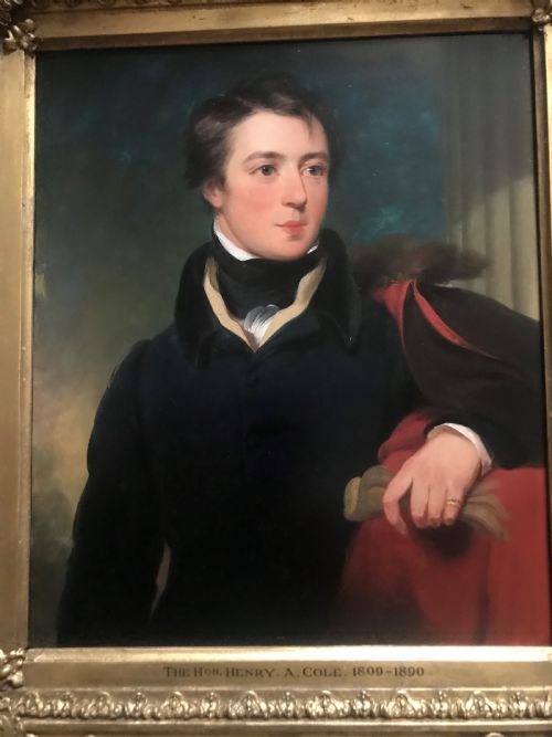 fig 1. An early 19th-century portrait painting of a gentleman wearing a dark coat and white cravat, encased in an ornate giltwood frame with a brass nameplate.