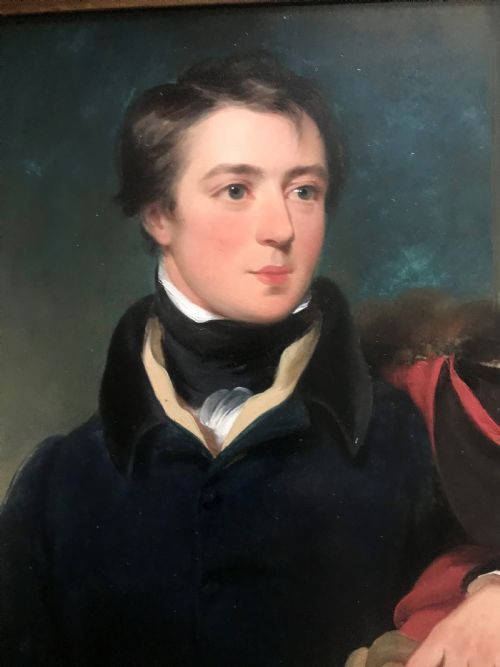 fig 2. An early 19th-century portrait painting of a gentleman wearing a dark coat and white cravat, encased in an ornate giltwood frame with a brass nameplate.