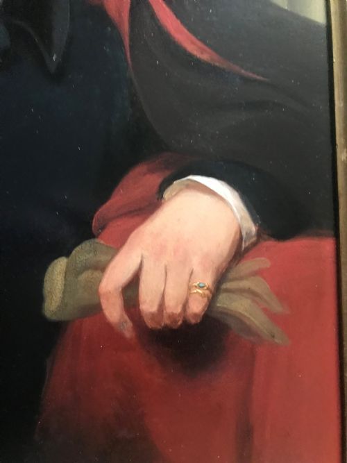 fig 4. An early 19th-century portrait painting of a gentleman wearing a dark coat and white cravat, encased in an ornate giltwood frame with a brass nameplate.