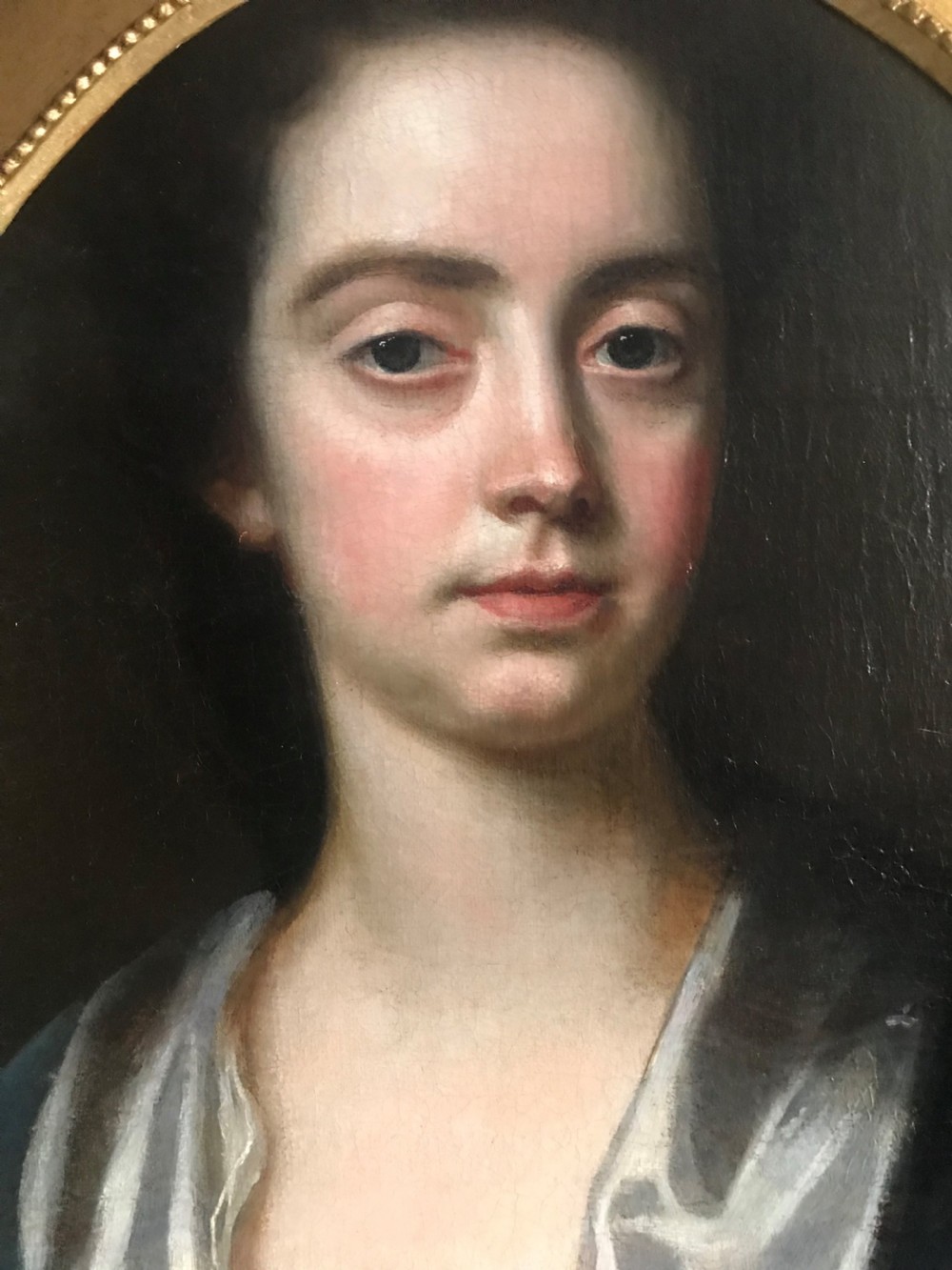 An 18th-century oil portrait of a lady in a white gown and blue mantle, framed by a feigned oval inside an ornate gold rectangular frame. View II