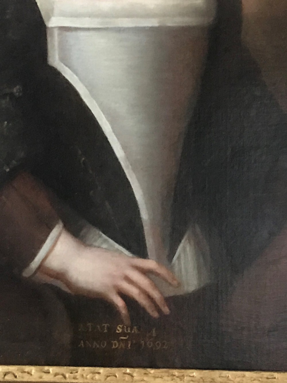 An antique seventeenth-century oil portrait of a young boy with light brown hair in period dress, set in a carved gilt frame. View III