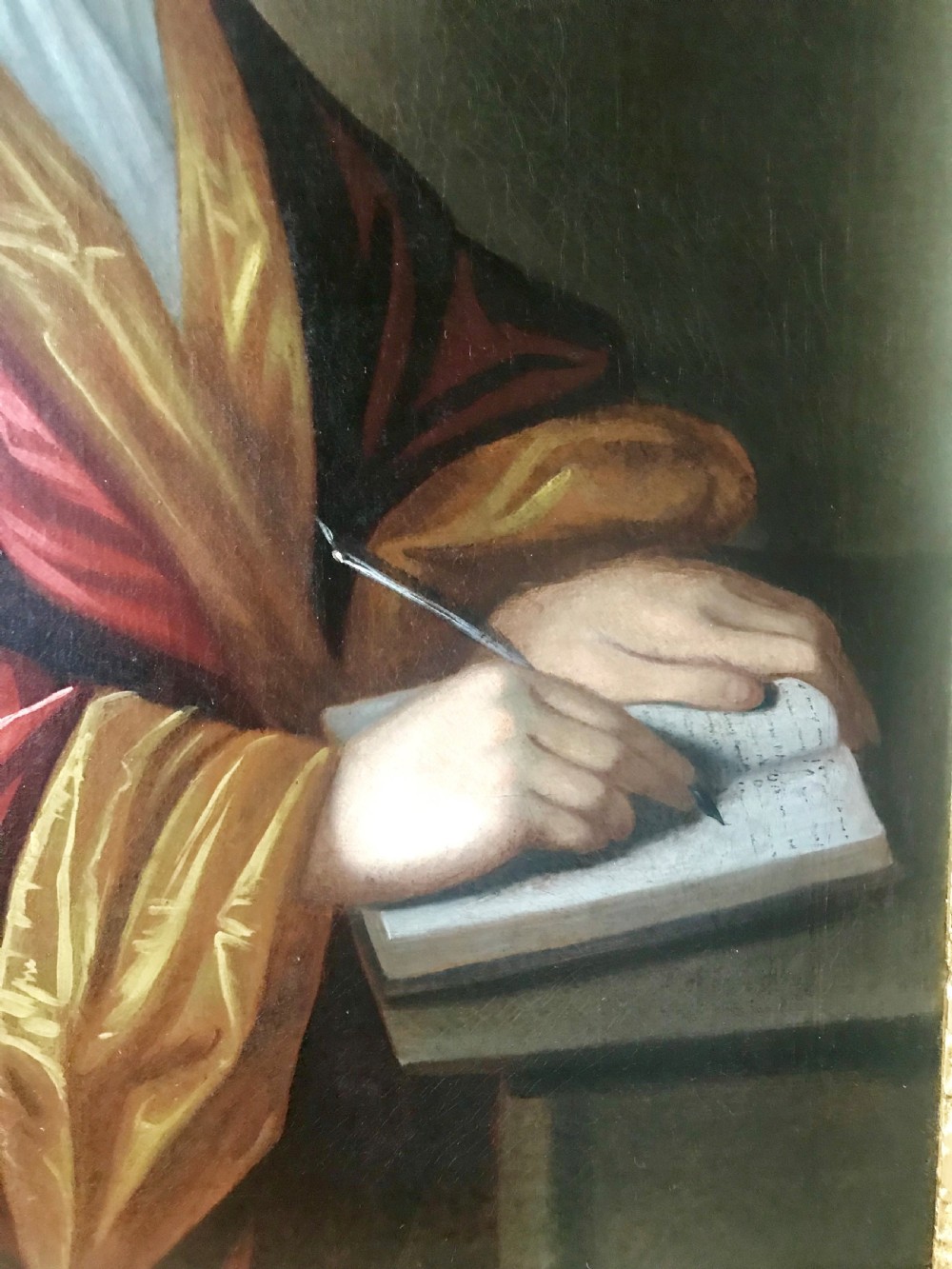 An early 18th-century oil painting on canvas depicting a gentleman in a full wig and red silk robe writing in a book, presented within a gilded frame. View IV