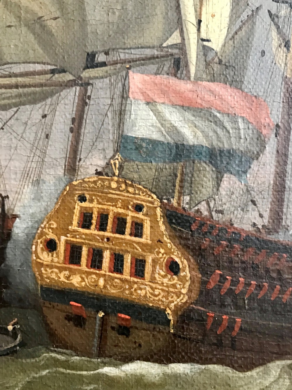 An antique seventeenth-century oil painting depicting Dutch warships engaged in a sea battle, housed within a wide marbled frame. View III