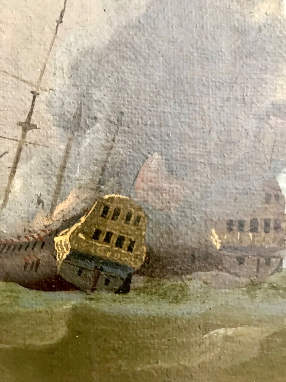 An antique seventeenth-century oil painting depicting Dutch warships engaged in a sea battle, housed within a wide marbled frame. View V