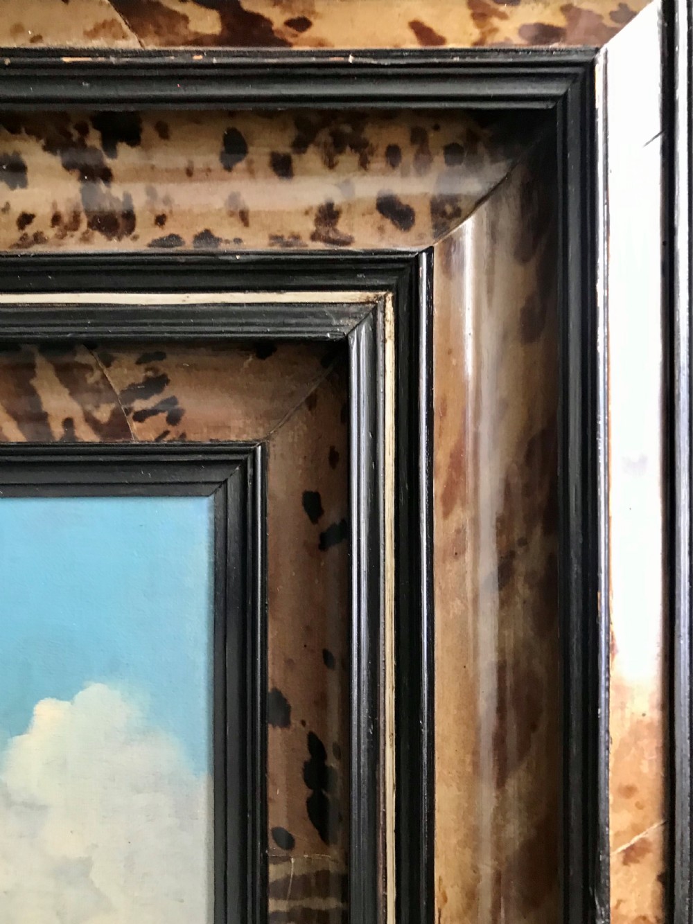 An antique seventeenth-century oil painting depicting Dutch warships engaged in a sea battle, housed within a wide marbled frame. View VI
