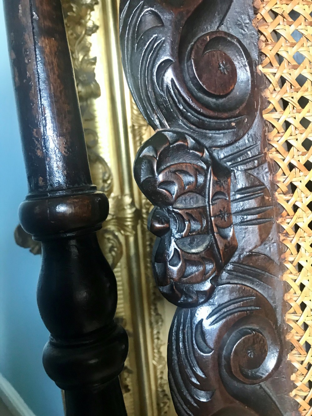 A late 17th-century dark carved beech side chair featuring a tall back with scrollwork, turned supports, and woven cane panels. View III