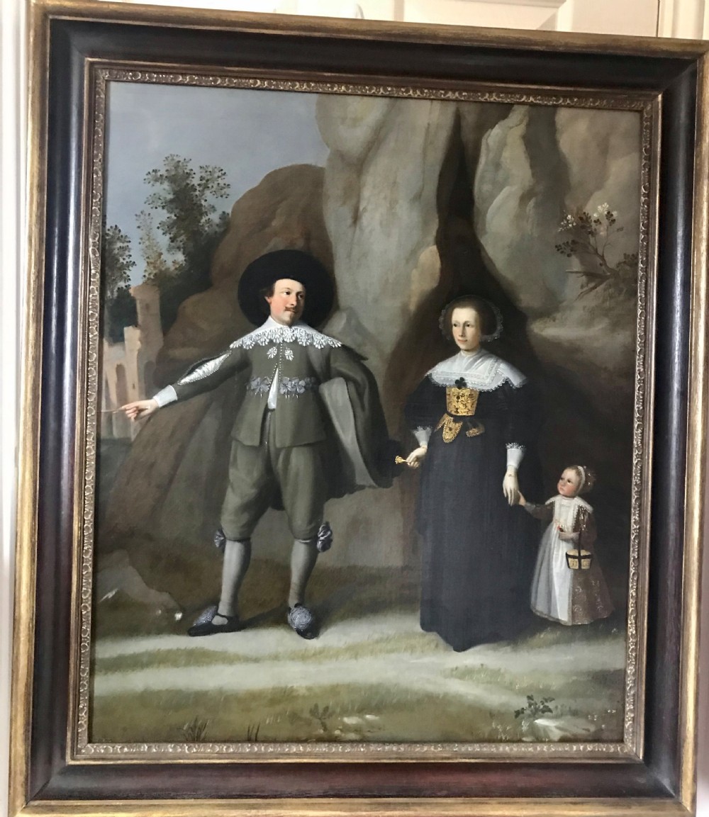 A seventeenth-century oil painting depicting a Dutch man, woman, and child standing outdoors in period costume against a rocky backdrop. View II