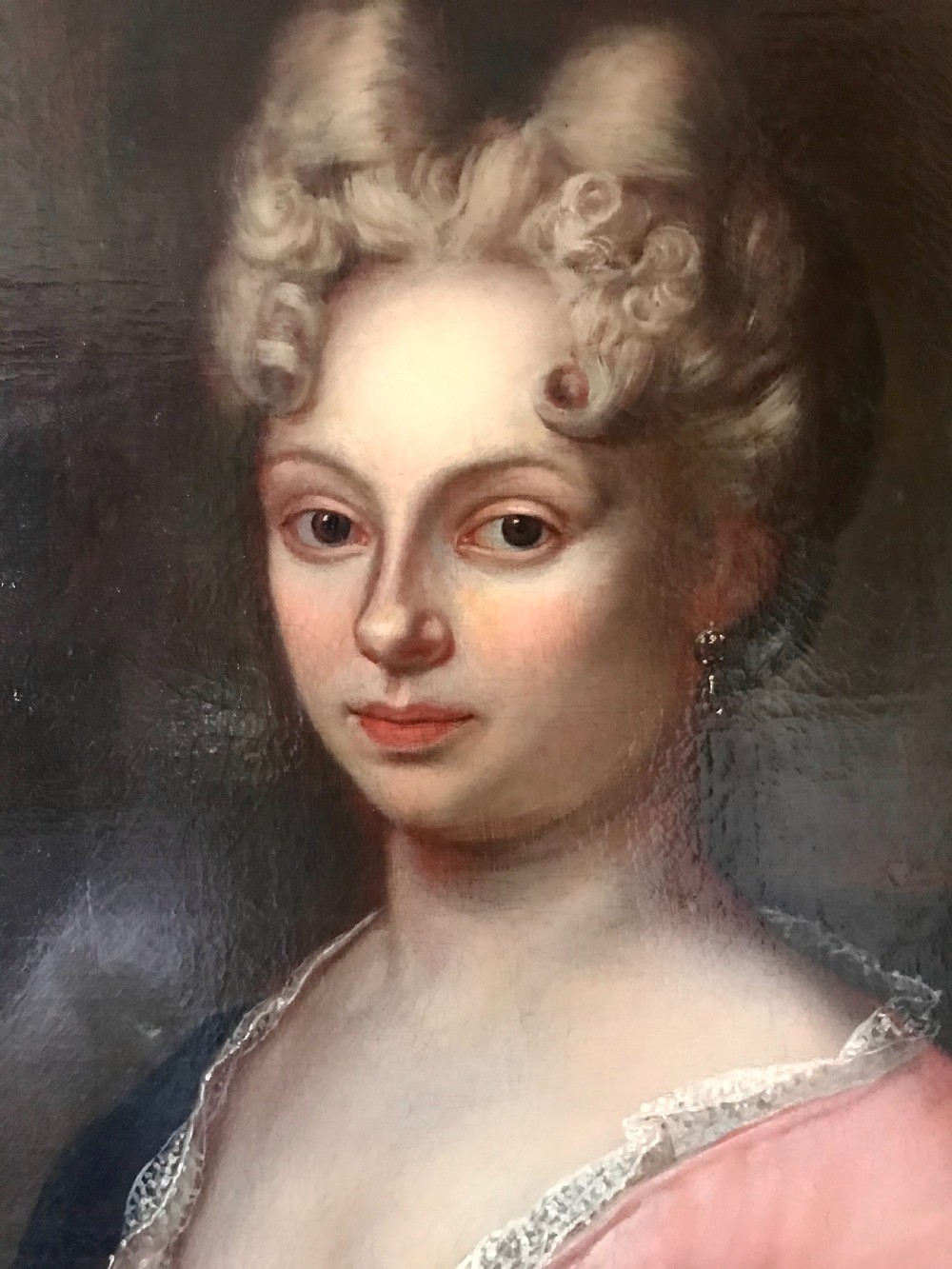 An 18th-century oil painting depicting a woman in a pink gown with lace trimming, set in a gilded wooden frame. View III