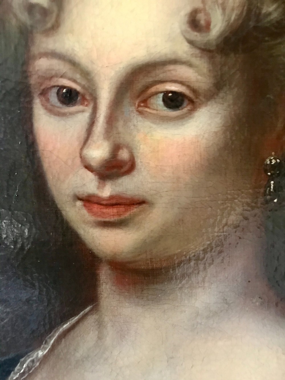 An 18th-century oil painting depicting a woman in a pink gown with lace trimming, set in a gilded wooden frame. View IV