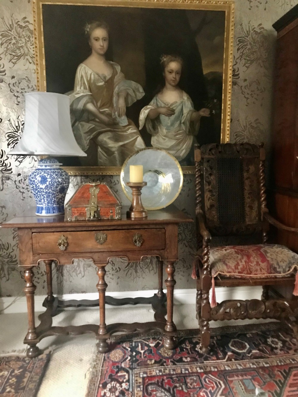 An early 18th-century oil painting depicting two young sisters in silk dresses set against a dark landscape within a gold leaf frame. View VII