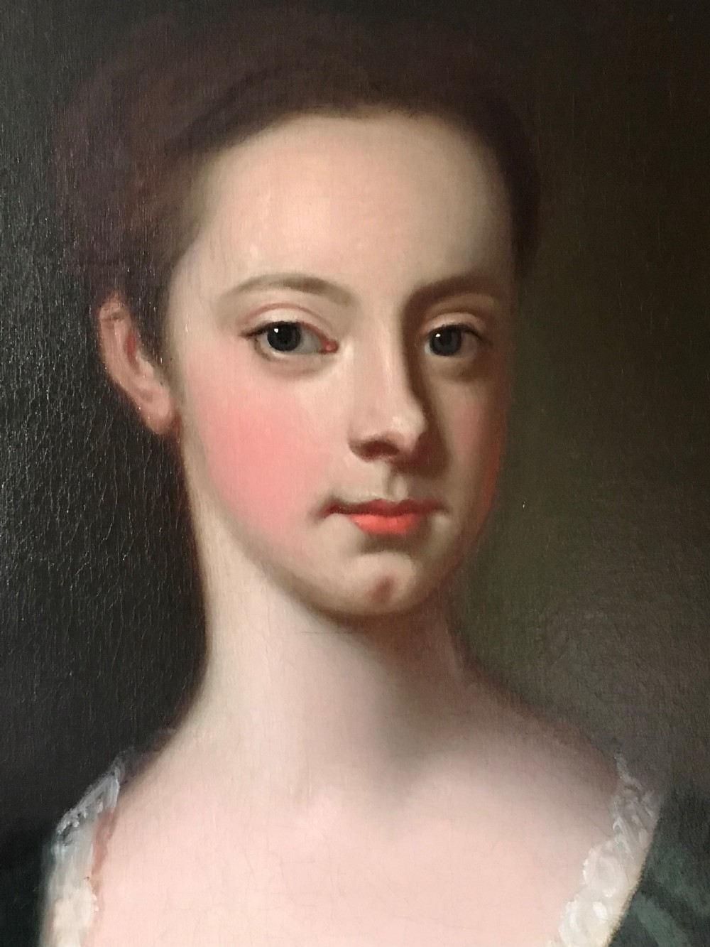 An 18th-century oval oil portrait on canvas depicting a lady in a green dress and purple mantle within a carved gilded frame. View III
