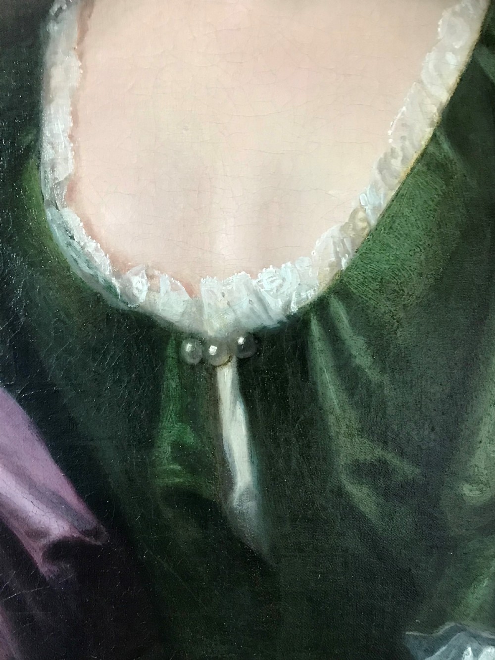 An 18th-century oval oil portrait on canvas depicting a lady in a green dress and purple mantle within a carved gilded frame. View IV