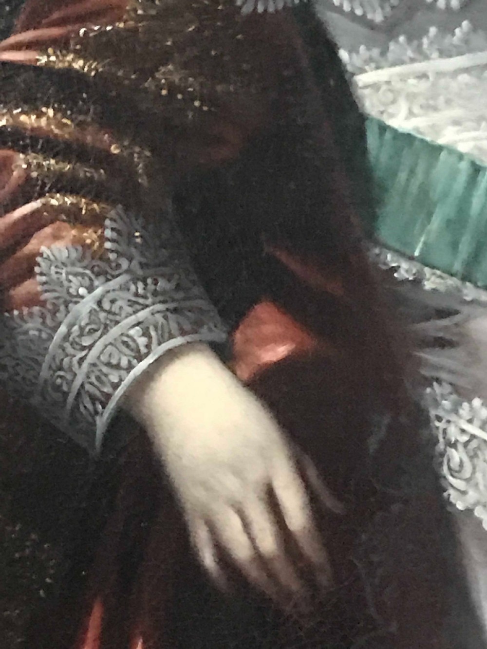 A seventeenth-century Baroque oil painting on canvas depicting a young child wearing a crimson feathered hat and ornate lace attire within a gilded wood frame. View VII