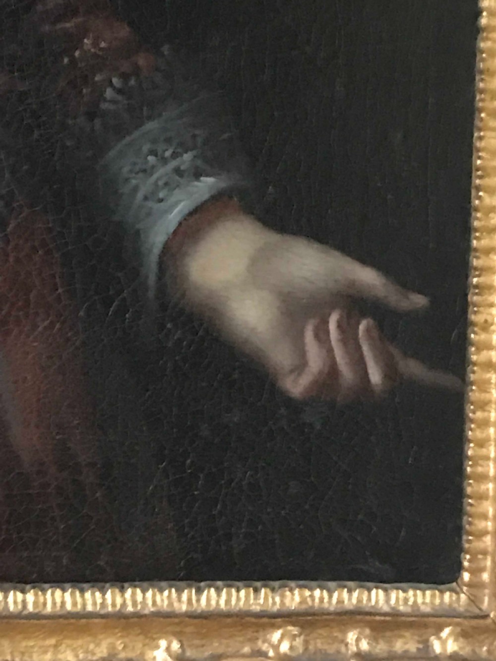 A seventeenth-century Baroque oil painting on canvas depicting a young child wearing a crimson feathered hat and ornate lace attire within a gilded wood frame. View VIII
