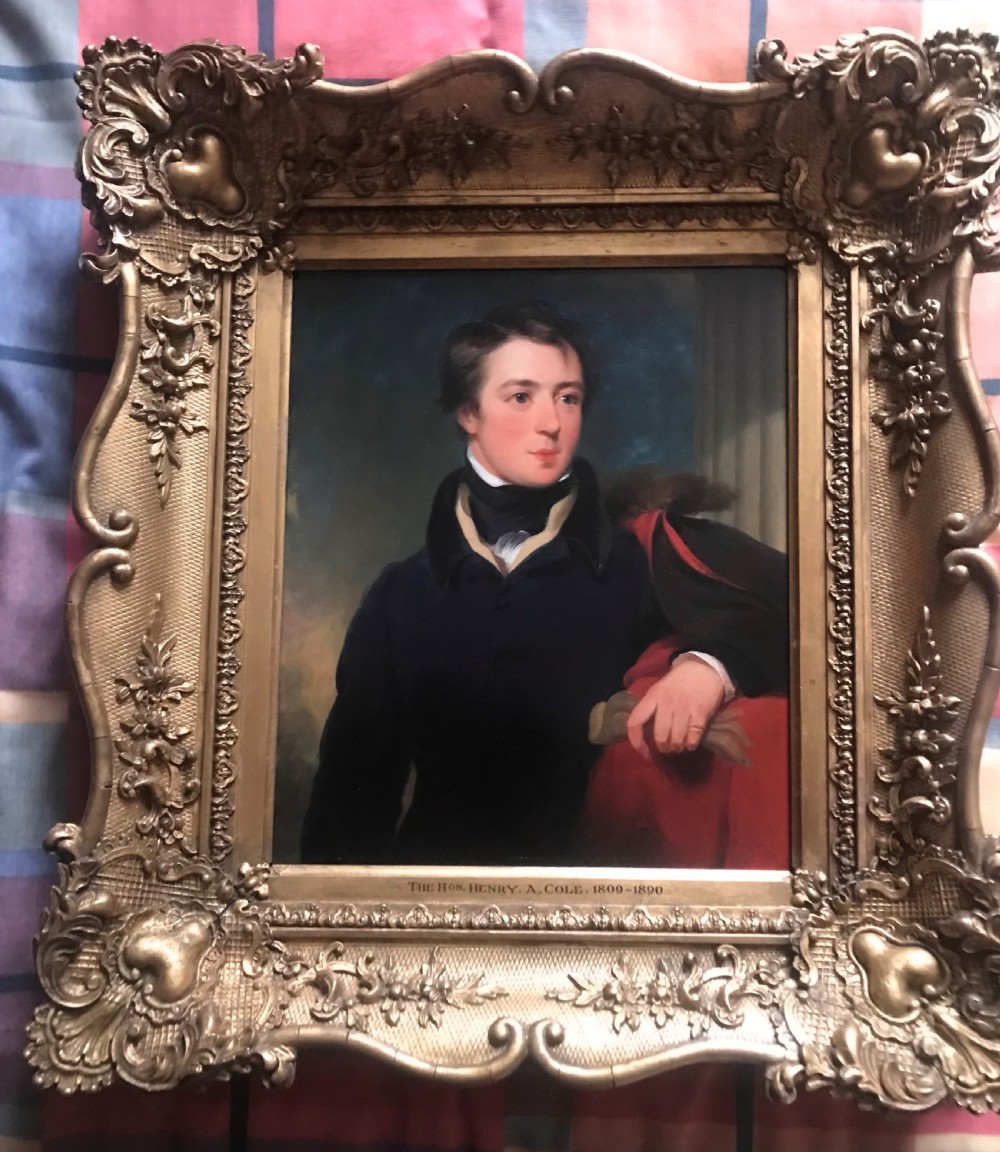 An early 19th-century portrait painting of a gentleman wearing a dark coat and white cravat, encased in an ornate giltwood frame with a brass nameplate.