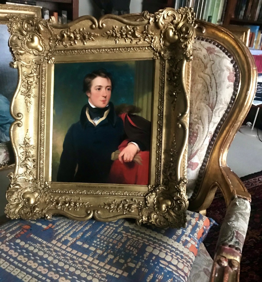 An early 19th-century portrait painting of a gentleman wearing a dark coat and white cravat, encased in an ornate giltwood frame with a brass nameplate. View VI