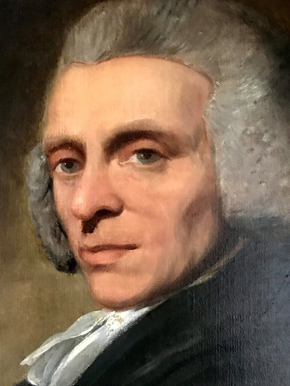 A late 18th-century oil portrait of a seated clergyman wearing a powdered wig and dark coat, set within a moulded gilded frame. View III