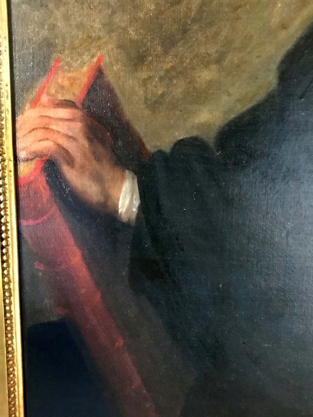 A late 18th-century oil portrait of a seated clergyman wearing a powdered wig and dark coat, set within a moulded gilded frame. View IV