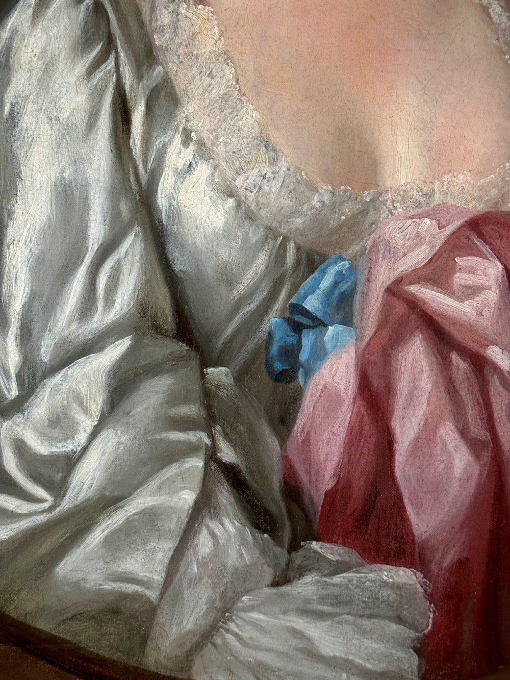 An 18th-century oil portrait of a woman in a pink and white dress set within a feigned oval and enclosed by a gold carved giltwood frame. View IV