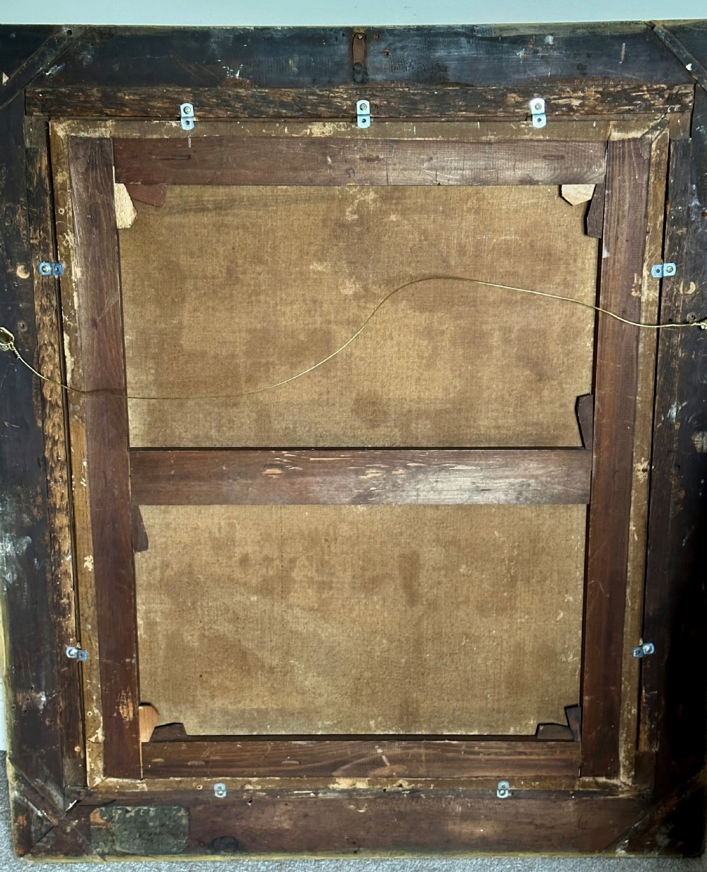 An 18th-century oil portrait of a woman in a pink and white dress set within a feigned oval and enclosed by a gold carved giltwood frame. View V