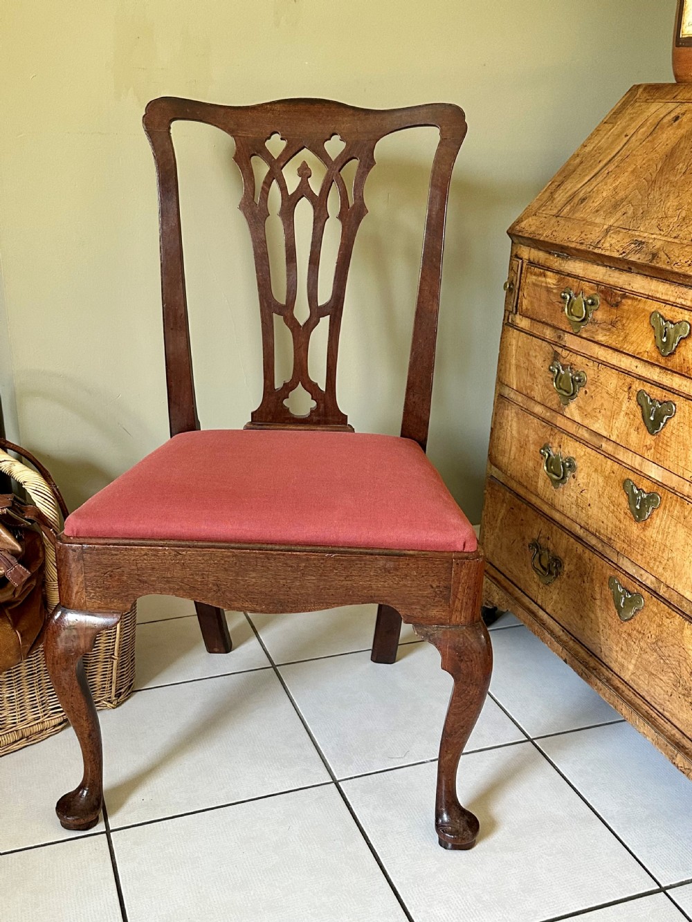 A Georgian mahogany side chair featuring cabriole front legs, a Gothic pierced splat back, and a red fabric drop-in seat.