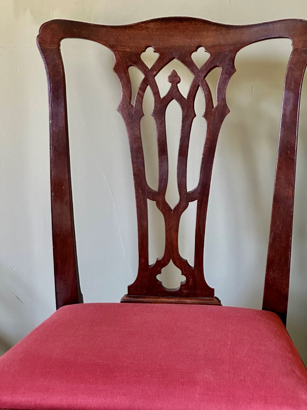 A Georgian mahogany side chair featuring cabriole front legs, a Gothic pierced splat back, and a red fabric drop-in seat. View II